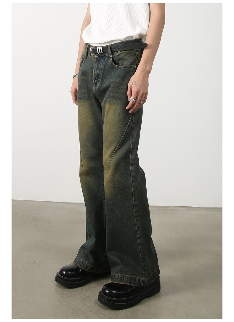 Side profile of wide-leg olive-green jeans showing distinctive seam pattern and faded effects, paired with white top and chunky black shoes