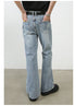Rear view of light wash denim wide-leg jeans showing pocket placement and seam details, styled with black t-shirt and designer belt