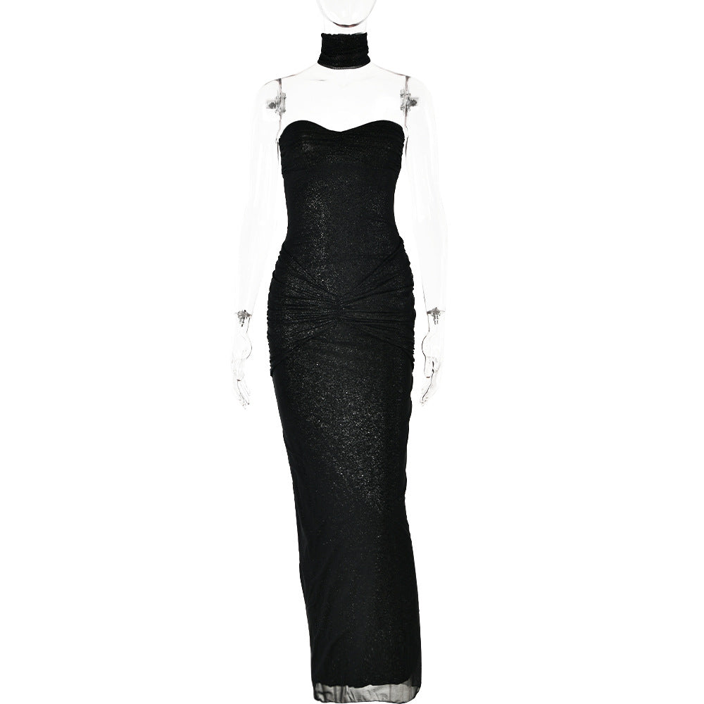 Black strapless evening gown displayed on a transparent mannequin, showcasing its ruched detailing and elegant silhouette