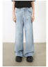 A model in black t-shirt and light blue high-waisted wide-leg jeans. Classic five-pocket styling with relaxed fit and clean silhouette. Paired with chunky black shoes