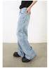 Side profile of model in black top with hand in pocket of light-wash wide-leg jeans and platform shoes