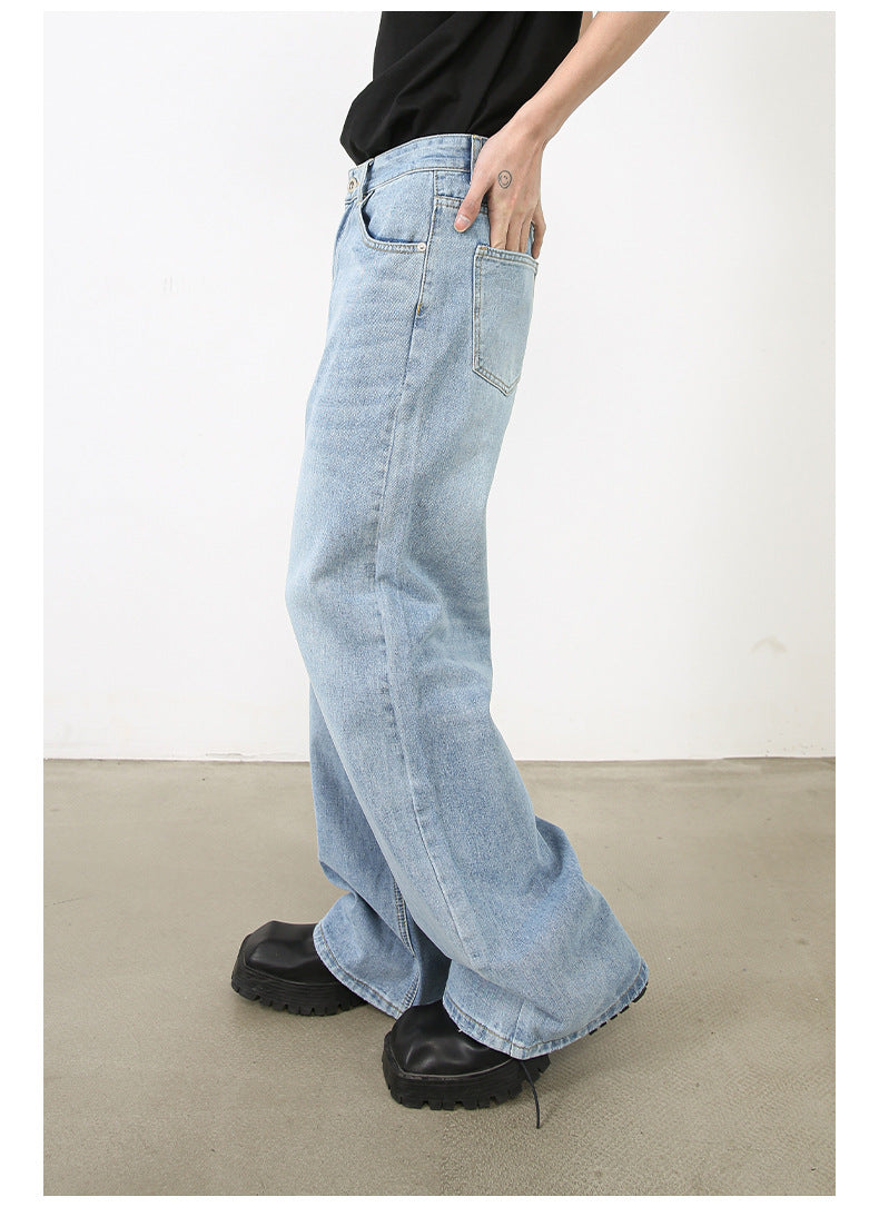 Side profile of model in black top with hand in pocket of light-wash wide-leg jeans and platform shoes