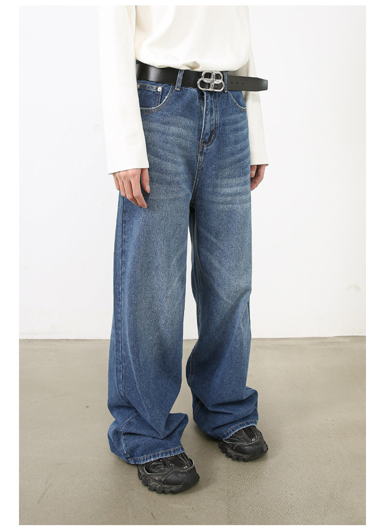 Model wearing white top and medium-blue wide-leg jeans with BB logo belt and platform black shoes