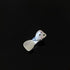 Pearl white hair clip with star and crystal embellishments on black surface