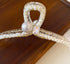 Clear hair clip decorated with pearl beading and crystal accents