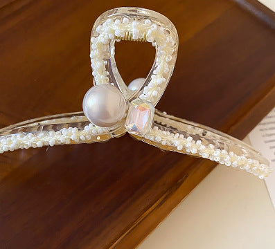 Clear hair clip decorated with pearl beading and crystal accents