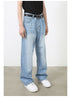 A model is wearing light blue wide-leg denim jeans with a black top and belt, standing in a neutral studio setting