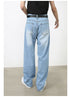 A model is wearing light blue wide-leg jeans with a black top and belt, showing the back view against white background