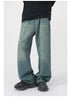 Side and front views of vintage-wash wide-leg green denim pants with black top and black chunky sneakers