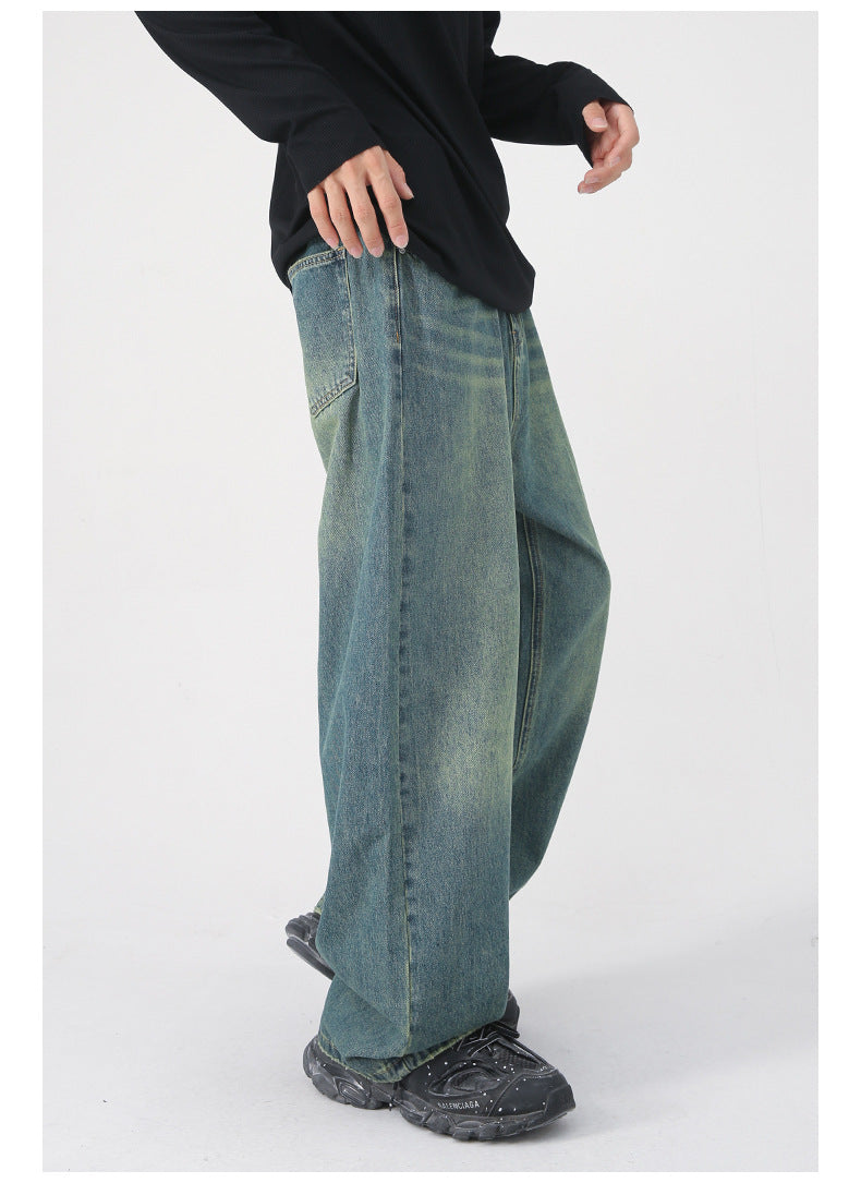 Model wearing purple wide-leg jeans with black belt, black top and two-tone loafers against white background