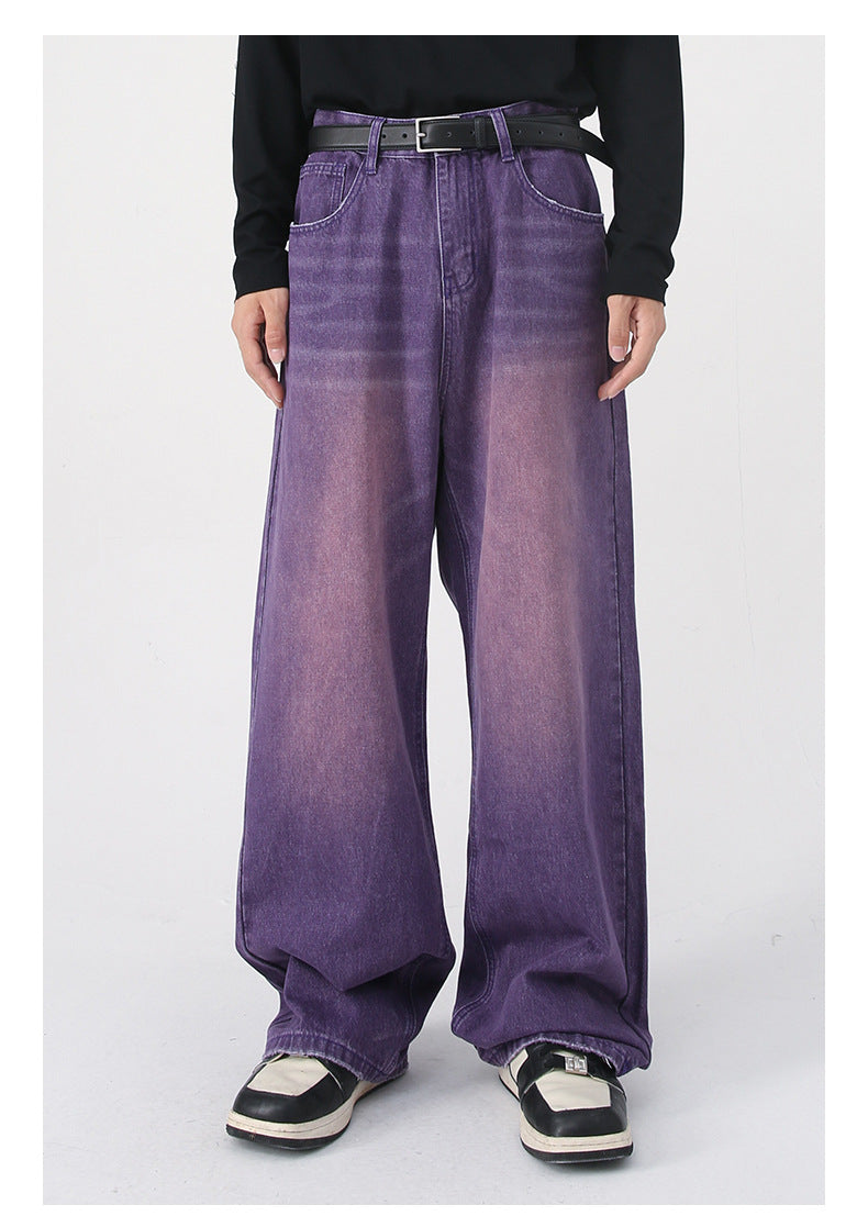 Side view of purple gradient wide-leg jeans with black belt, black sweater and black and white loafers