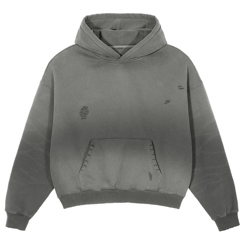 Product shot of grey ombre hoodie with distressed details, kangaroo pocket and ribbed hem on white background