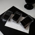 Black bobby pin packs displayed on white paper with 'cold box' text, modern beauty product presentation