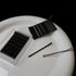 Two packs of black bobby pins with loose pins on white ceramic surface, minimalist beauty flatlay