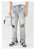 Front view of ripped light wash jeans styled with oversized white tee, silver accessories and retro sneakers against white