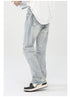 Side view highlighting ripped knee detail and straight leg silhouette of light wash jeans against white backdrop