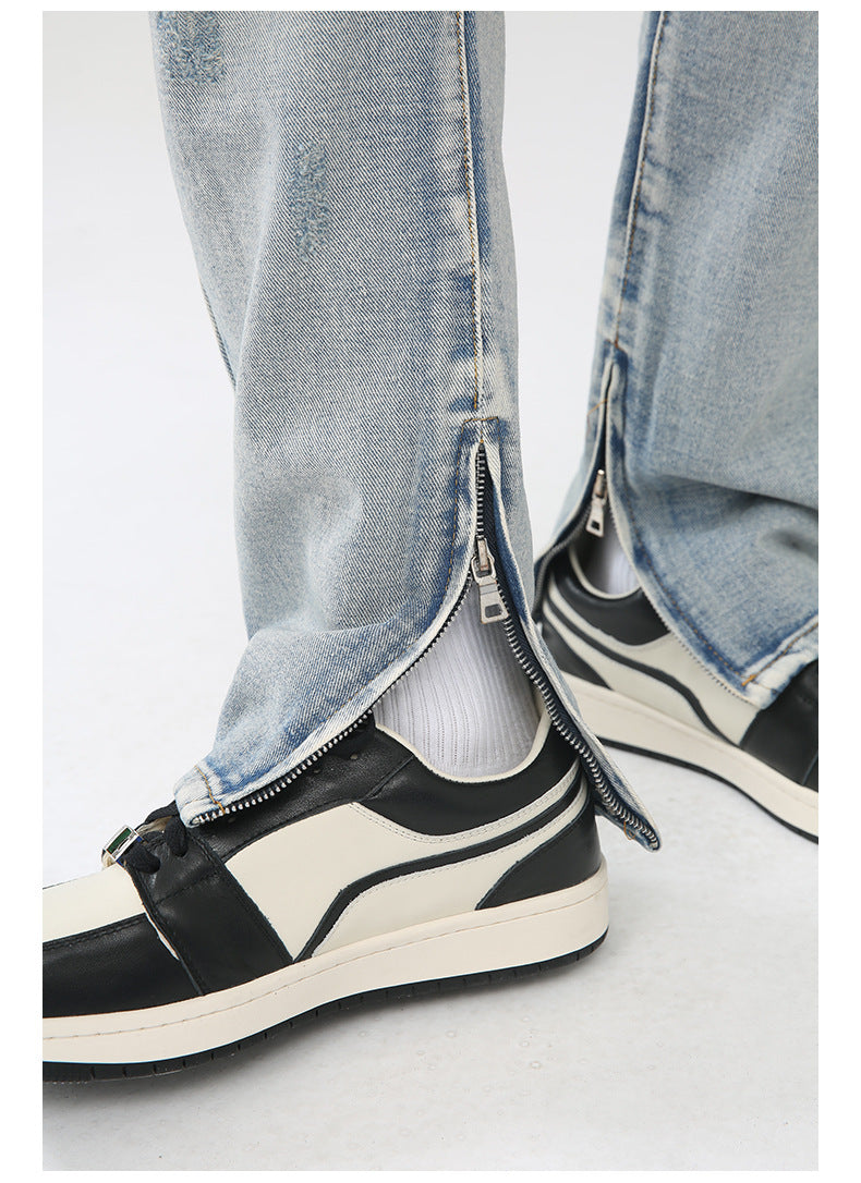 Close-up detail of silver ankle zip opening and white sock styling with black and cream retro sneaker