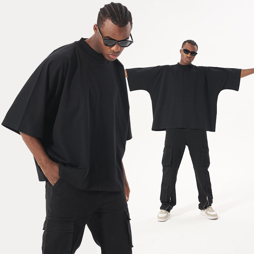 Split image showing model with hands in pockets and same model with arms outstretched wearing all-black streetwear outfit
