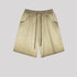 Light beige washed cotton shorts with drawstring waist and side pockets displayed flat against light gray background