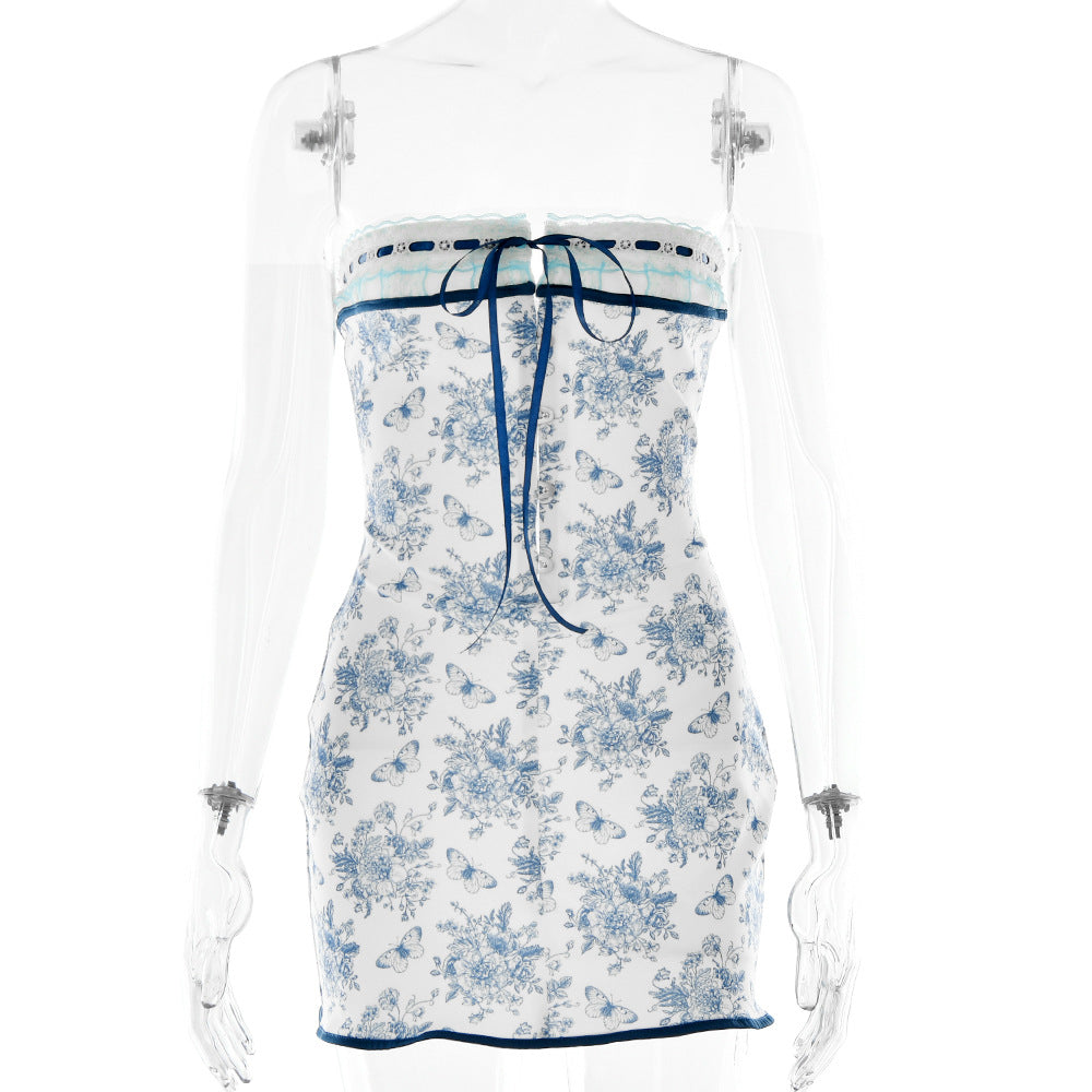 A white and blue butterfly-print mini dress with corset-style front displayed on a transparent mannequin against white background