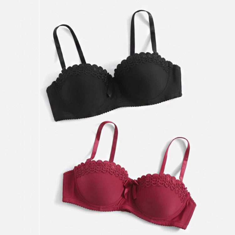 Product display of two push-up bras with lace trim and bow detail, shown in black and burgundy colors against white background