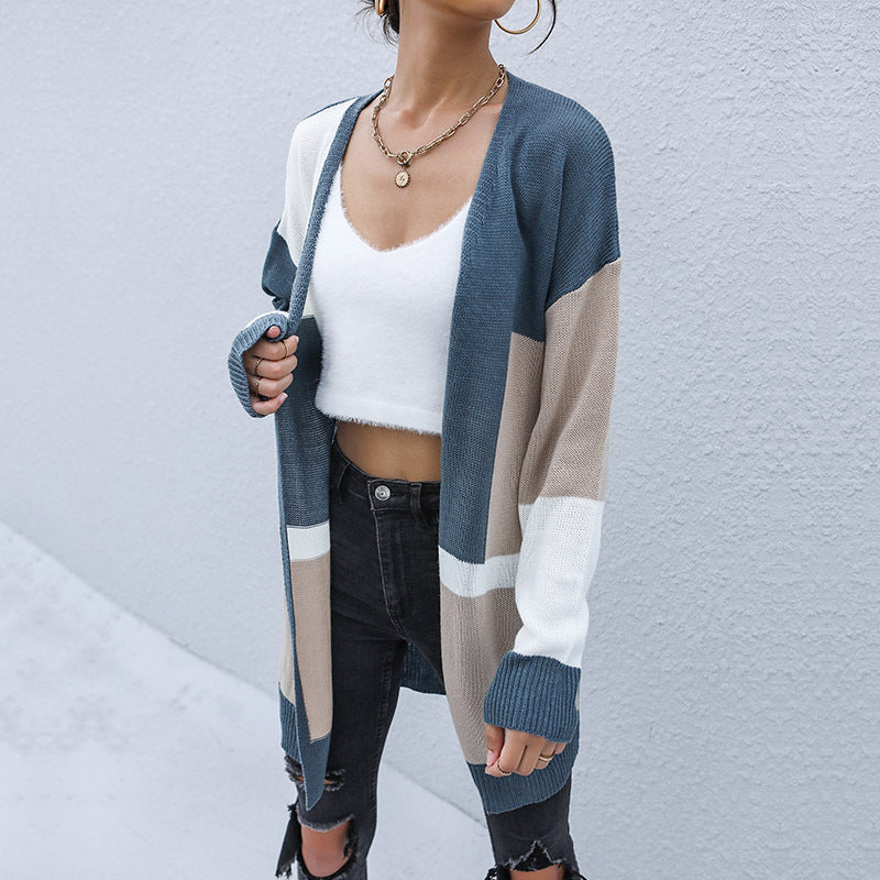 Oversized colorblock cardigan with slate blue, beige and white panels, styled with crop top and black jeans