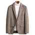 A mannequin wearing a beige glen plaid blazer with white turtleneck. Single-button closure, notched lapels and flap pockets create a refined smart-casual look