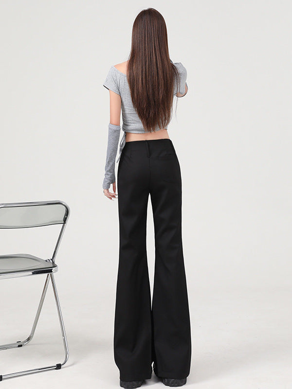 Back view, full-body shot of black Y2K pants with low waist and smooth back pockets.