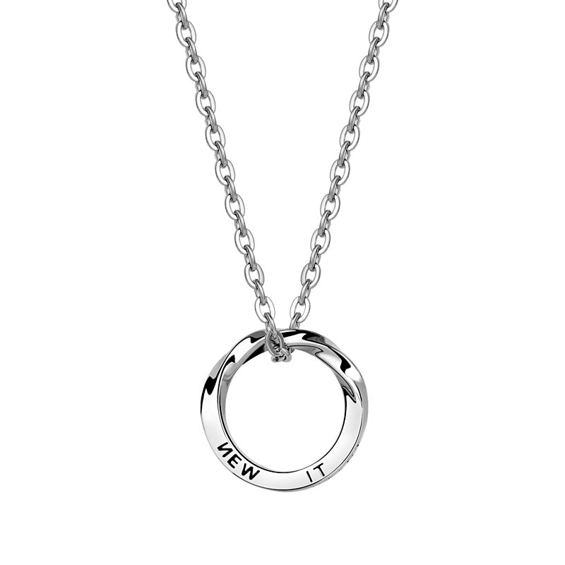 Close-up of silver twisted ring pendant with 'ROAD' text engraving