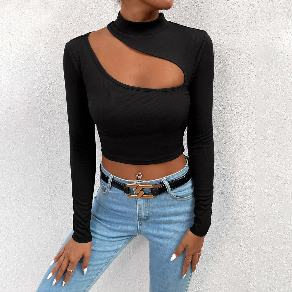 Detailed view of black long-sleeve crop top with asymmetrical cutout and mock neck