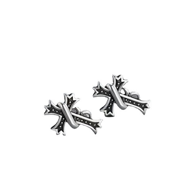 Product photo of silver cross stud earrings pair with black antiqued details on white background
