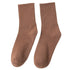 A pair of brown ribbed crew socks displayed flat against cream background showing texture and full length