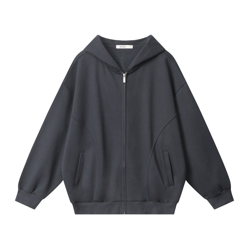 A dark gray oversized zip-up hoodie with a hood, silver zipper, and two front pockets is displayed flat on a white background