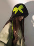 Black fuzzy winter hat adorned with neon green crochet bow and coordinating braided ties