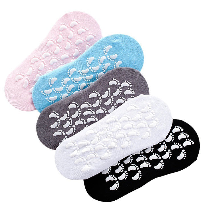 Five non-slip ankle socks in pink, blue, gray, white and black colors stacked showing grip soles against white background