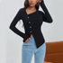 Detail shot of black ribbed top showing unique button placement and asymmetric cut with light denim