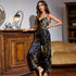 Black satin pajama set with intricate floral print, featuring a spaghetti strap top and wide-leg pants, styled with vintage decor