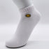 Close-up of white cotton ankle sock with yellow smiley face embroidery detail