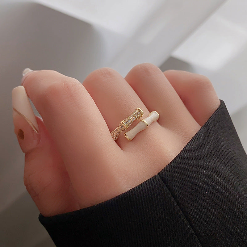 Bamboo style ring with gold and white segments on hand