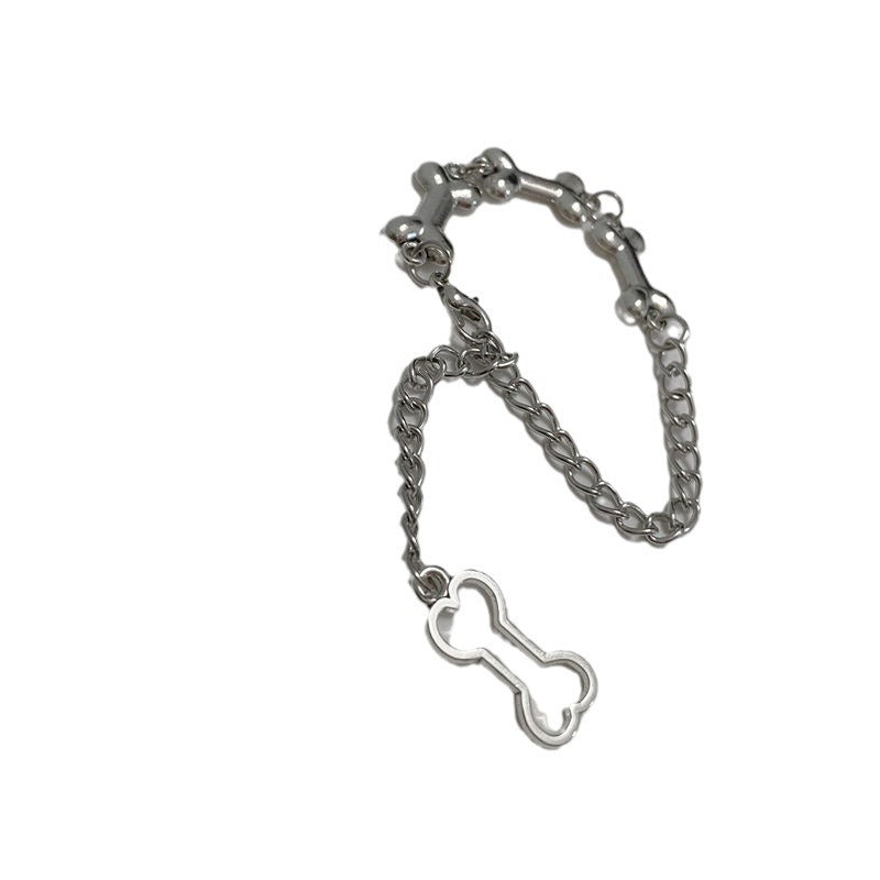 Silver dog bone bracelet laid flat on white background
