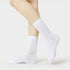 Side view of model's ankles wearing white ribbed crew sports socks with detailed texture visible against white background