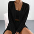 Close-up of black ribbed knit loungewear set showing detailed texture and crop top neckline design