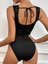 Back view of black lace bodysuit with scoop back and tie detail.