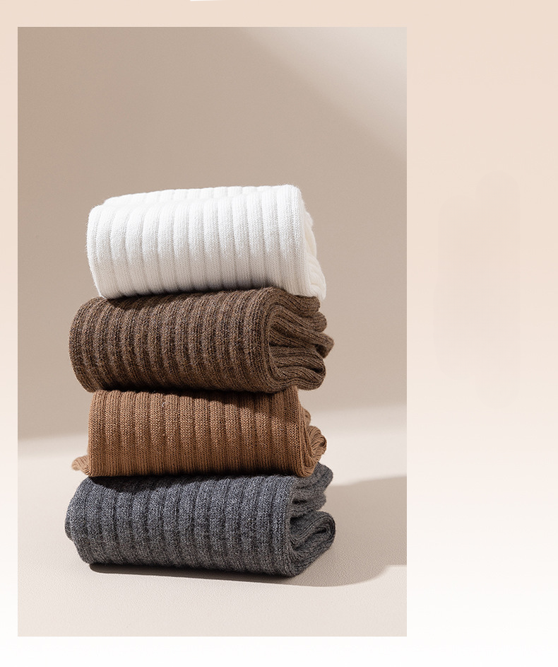 Pure cotton socks in neutral earthy tones - white, gray, beige, and brown - arranged with care tag