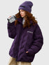 Woman holding vintage camcorder wearing purple Aesthetic puffer jacket with coordinating purple knit beanie and white sweater