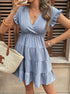Woman taking a mirror selfie wearing a baby blue ruffle sleeve babydoll dress with a woven tote.