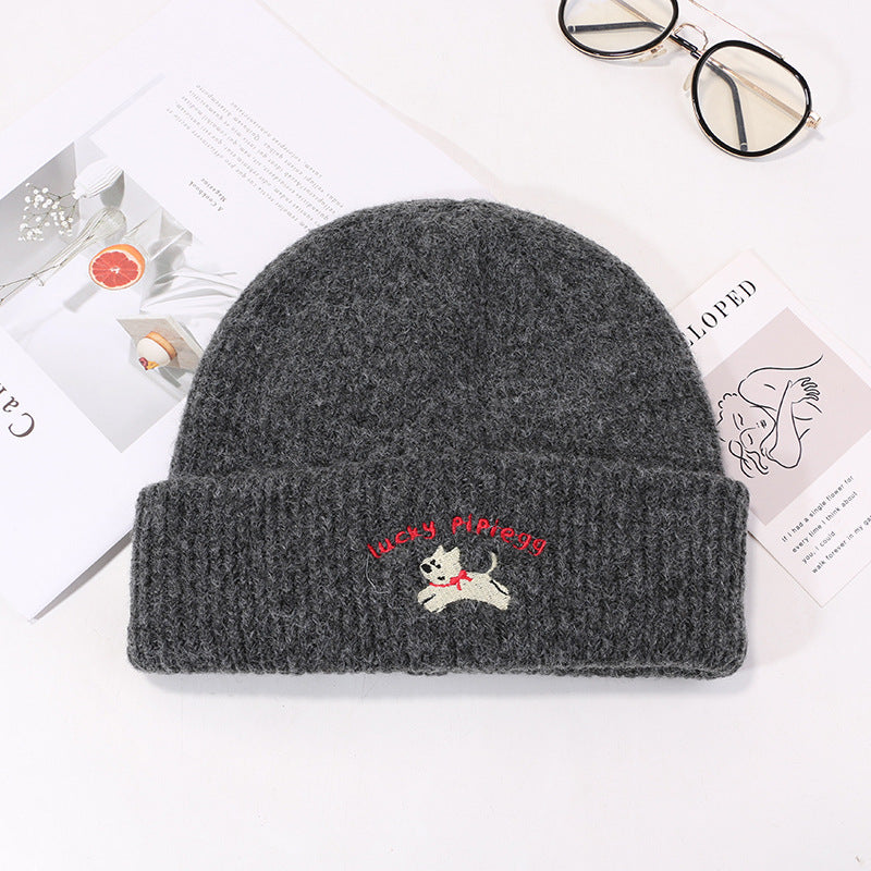 Charcoal gray beanie with red Lucky Pipiegg text and white puppy embroidery