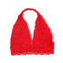 A red lace halter bralette laid flat, displaying scalloped edges and floral lace patterns