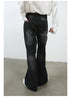 Rear three-quarter view of model with hand in pocket wearing white shirt and black wide-leg jeans against white background