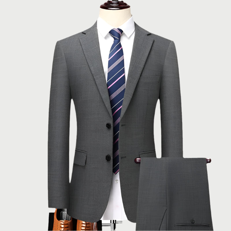 Gray wool suit displayed on mannequin with white shirt and navy striped tie featuring subtle pink accents